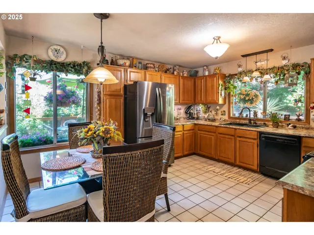 a kitchen with granite countertop a sink cabinets and stainless steel appliances