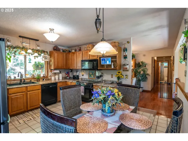 a kitchen with a sink a stove and chairs