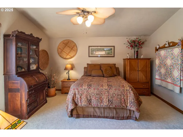 a bedroom with a bed and dresser with mirror