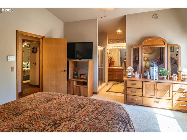 a bedroom with a bed and a flat screen tv