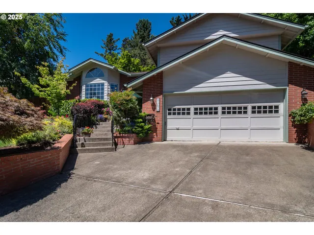 a view of a house with a yard and potted plants