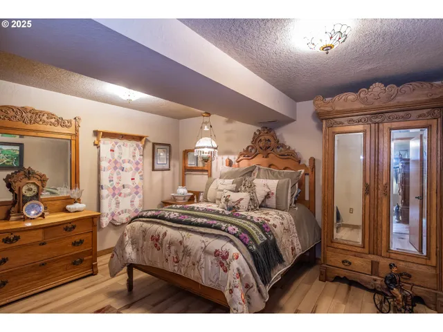 a bedroom with a bed and a large mirror