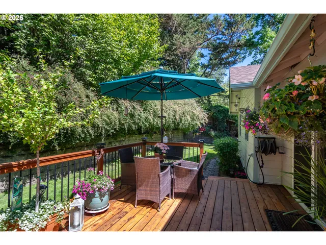 a view of a balcony with chairs and an umbrella
