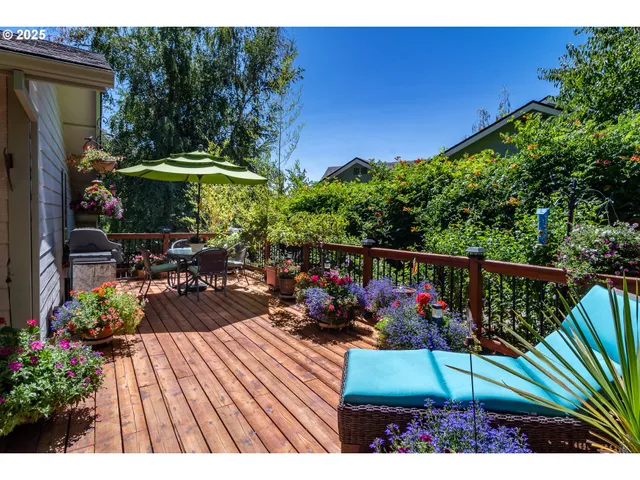 a view of a patio with table and chairs under an umbrella