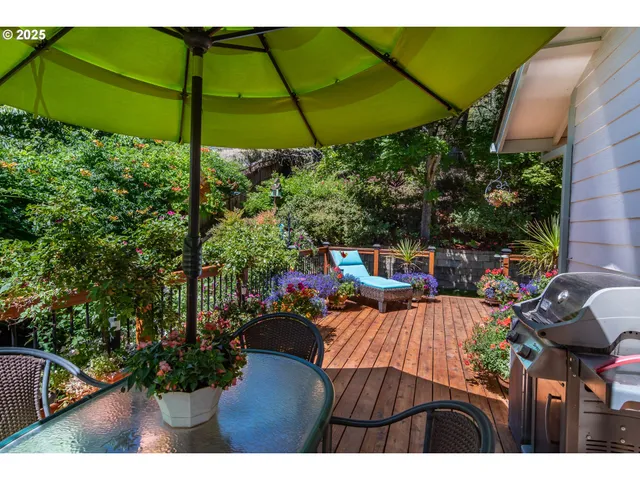 a view of a chairs and table on the wooden deck
