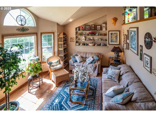 a living room with furniture and a floor to ceiling window