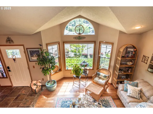 a view of a dining room with wooden floor and a potted plant