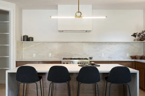 a kitchen with a table chairs and a stove