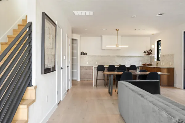 a living room with furniture a fireplace and a large window