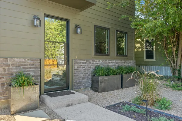 a front view of a house with a garden