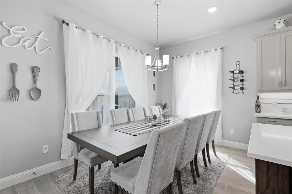3036 Deer Path Weatherford, TX 76085 - Photo 12 of 35 a view of a dining room with furniture and wooden floor
