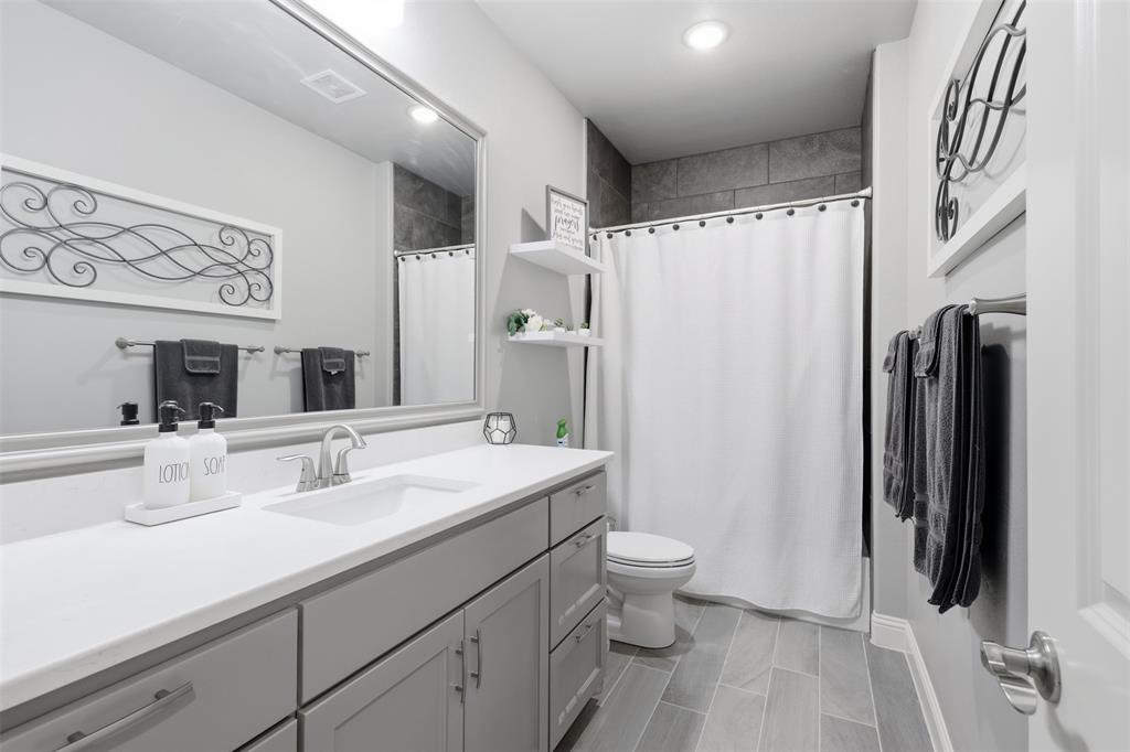 3036 Deer Path Weatherford, TX 76085 - Photo 25 of 35 a bathroom with a double vanity sink toilet and shower
