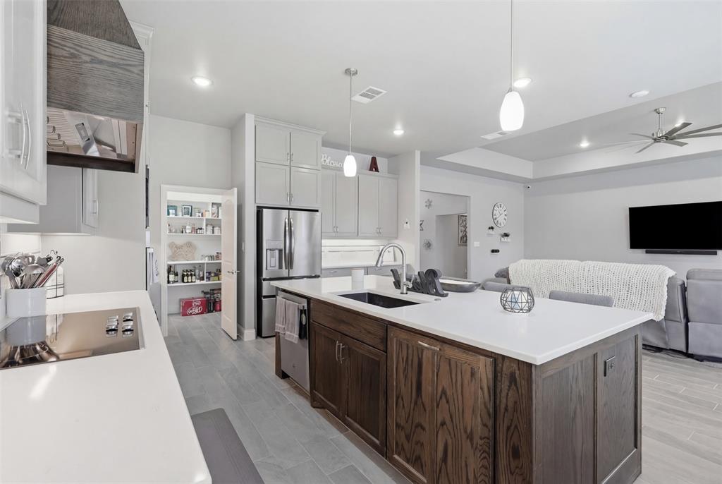 3036 Deer Path Weatherford, TX 76085 - Photo 7 of 35 a kitchen with kitchen island a sink stove and refrigerator