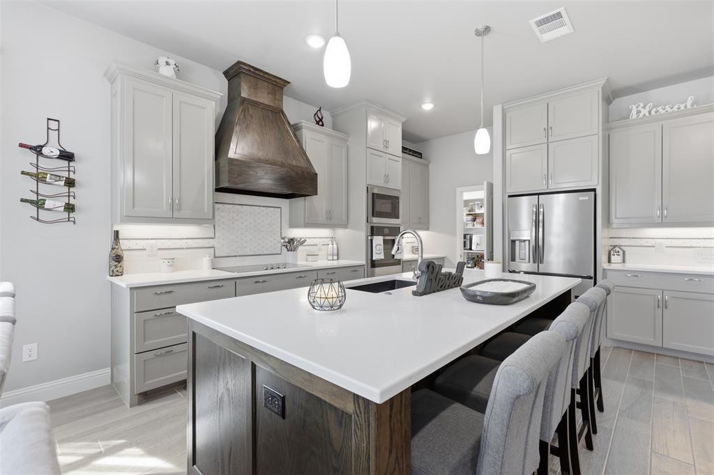 3036 Deer Path Weatherford, TX 76085 - Photo 8 of 35 a kitchen with a stove a refrigerator and a sink