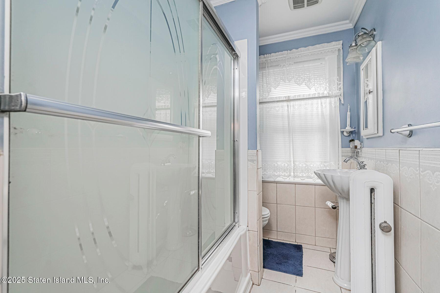 5300 Amboy Road Staten Island, NY 10312 - Photo 21 of 32 a bathroom with a shower and a sink