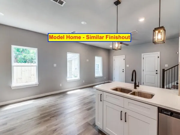 a view of a kitchen with kitchen island a stove and wooden floor