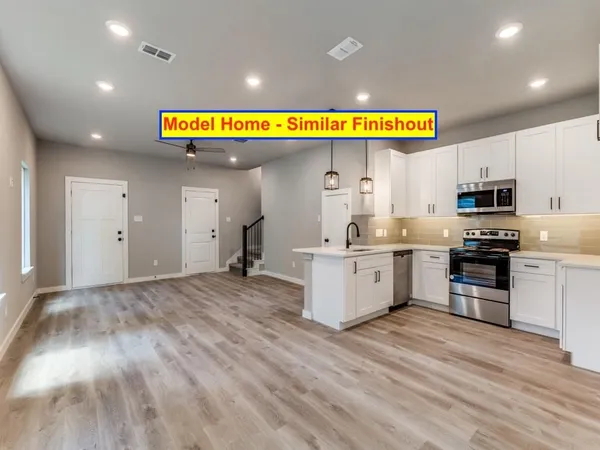 a kitchen with stainless steel appliances granite countertop a sink and a stove