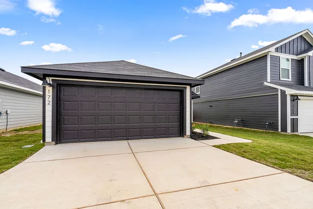 a view of backyard of house and garage