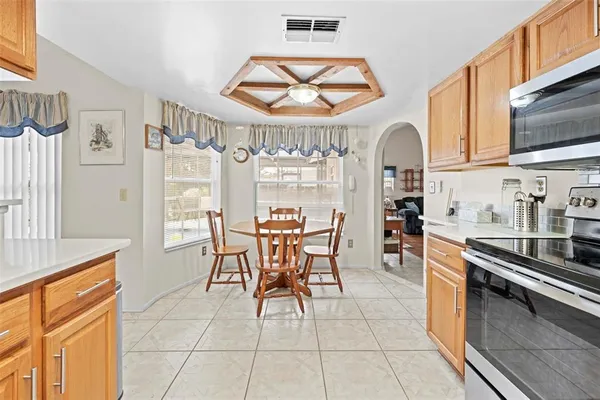 a kitchen with stainless steel appliances granite countertop a refrigerator and a stove