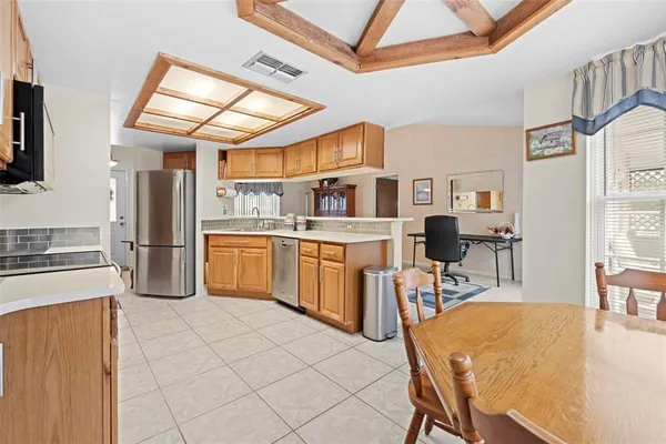 a large kitchen with stainless steel appliances granite countertop a stove and a sink