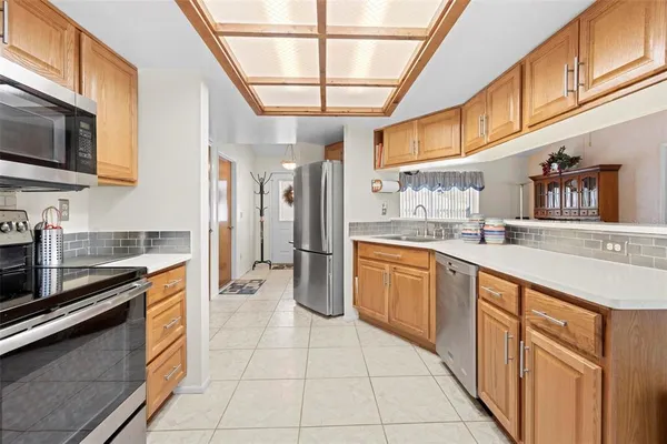 a kitchen with stainless steel appliances granite countertop a sink and cabinets