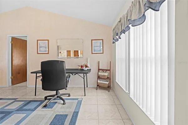 a view of a workspace with furniture and a window