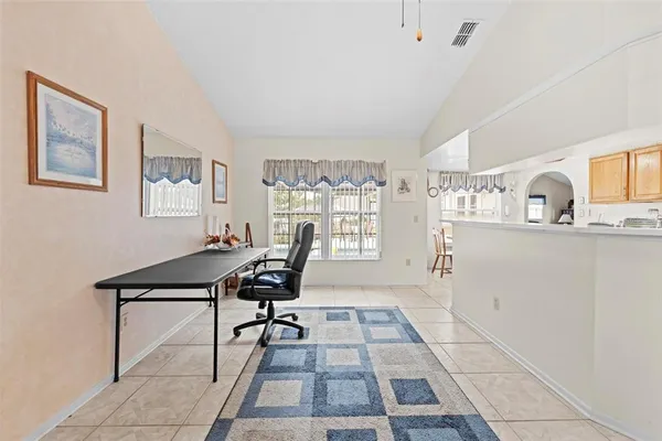 a view of a workspace with furniture and a window