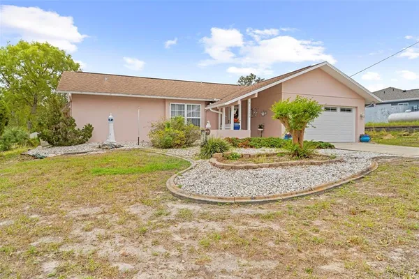 a view of a house with a swimming pool and a yard