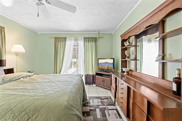 a bedroom with a large bed and a chandelier