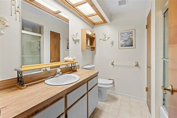 a bedroom with a bed dresser and a window
