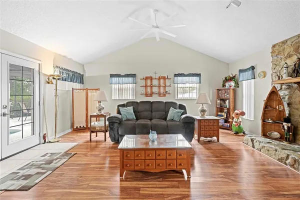a living room with furniture a rug and a window