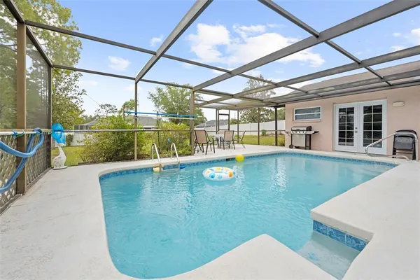 a view of pool with a yard