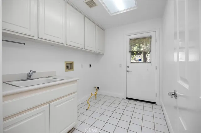 a kitchen with a sink cabinets and utility