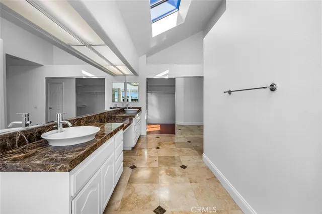 a large bathroom with a granite countertop sink a mirror and a shower