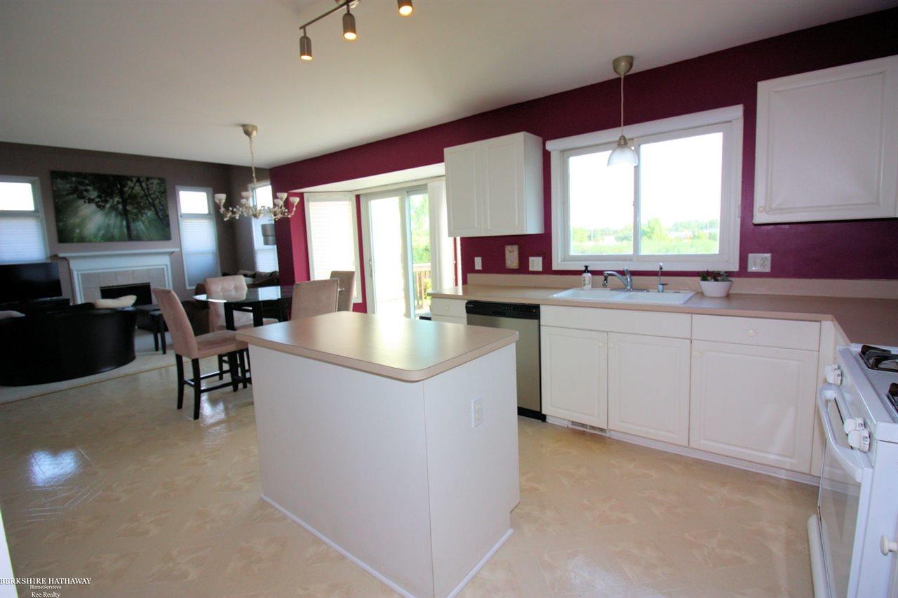 70692 Hillside Court Romeo, MI 48065 - Photo 15 of 37 The kitchen has a center island, desk area and plenty of cabinets and counter space. The door-wall (new) leads outside to the back 2-Tier Deck and brick Patio.