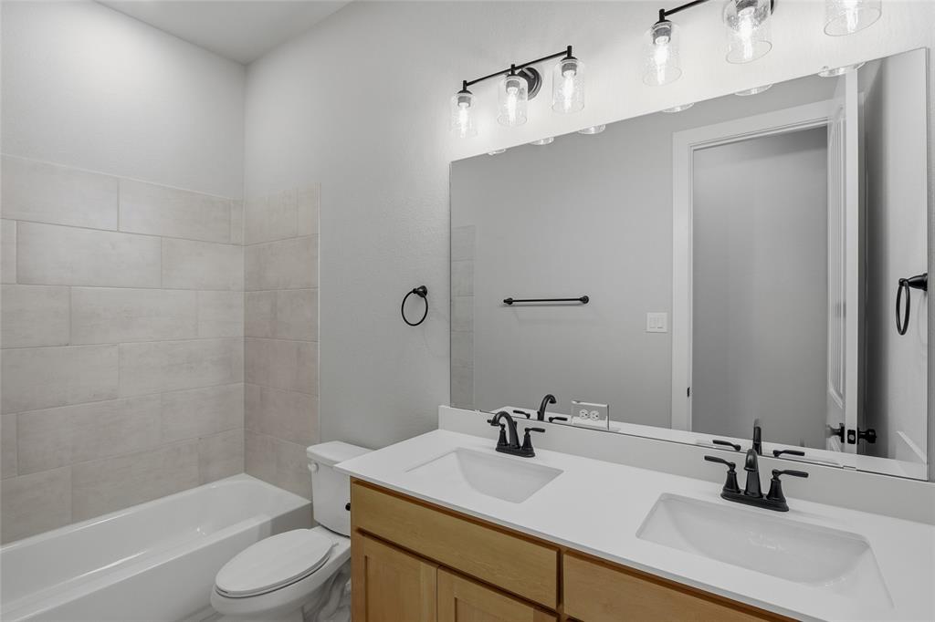 812 Vly Rdg Road Van Alstyne, TX 75495 - Photo 27 of 33 a bathroom with a sink a toilet and shower