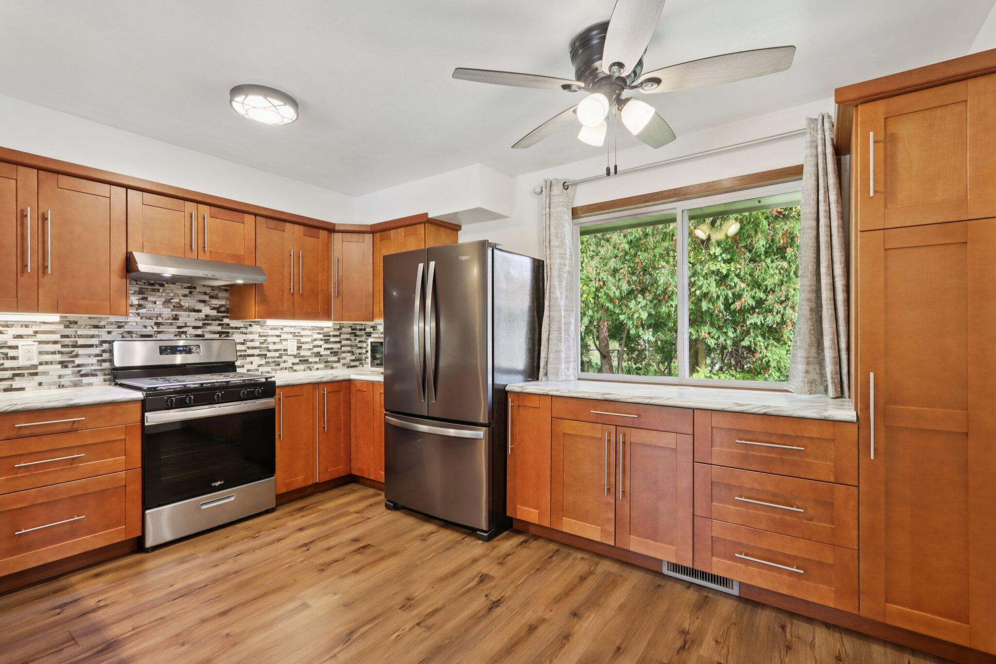 901 Anton Road Hartland, WI 53029 - Photo 11 of 48 Completely renovated kitchen with new stainless steel appliances, soft-close cabinets, and abundant storage.