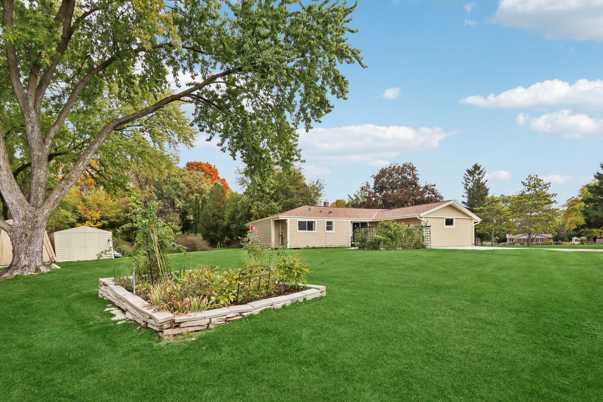 901 Anton Road Hartland, WI 53029 - Photo 33 of 48 .32 acres of meticulous landscaping, two raised garden beds, and a lovely flower bed.