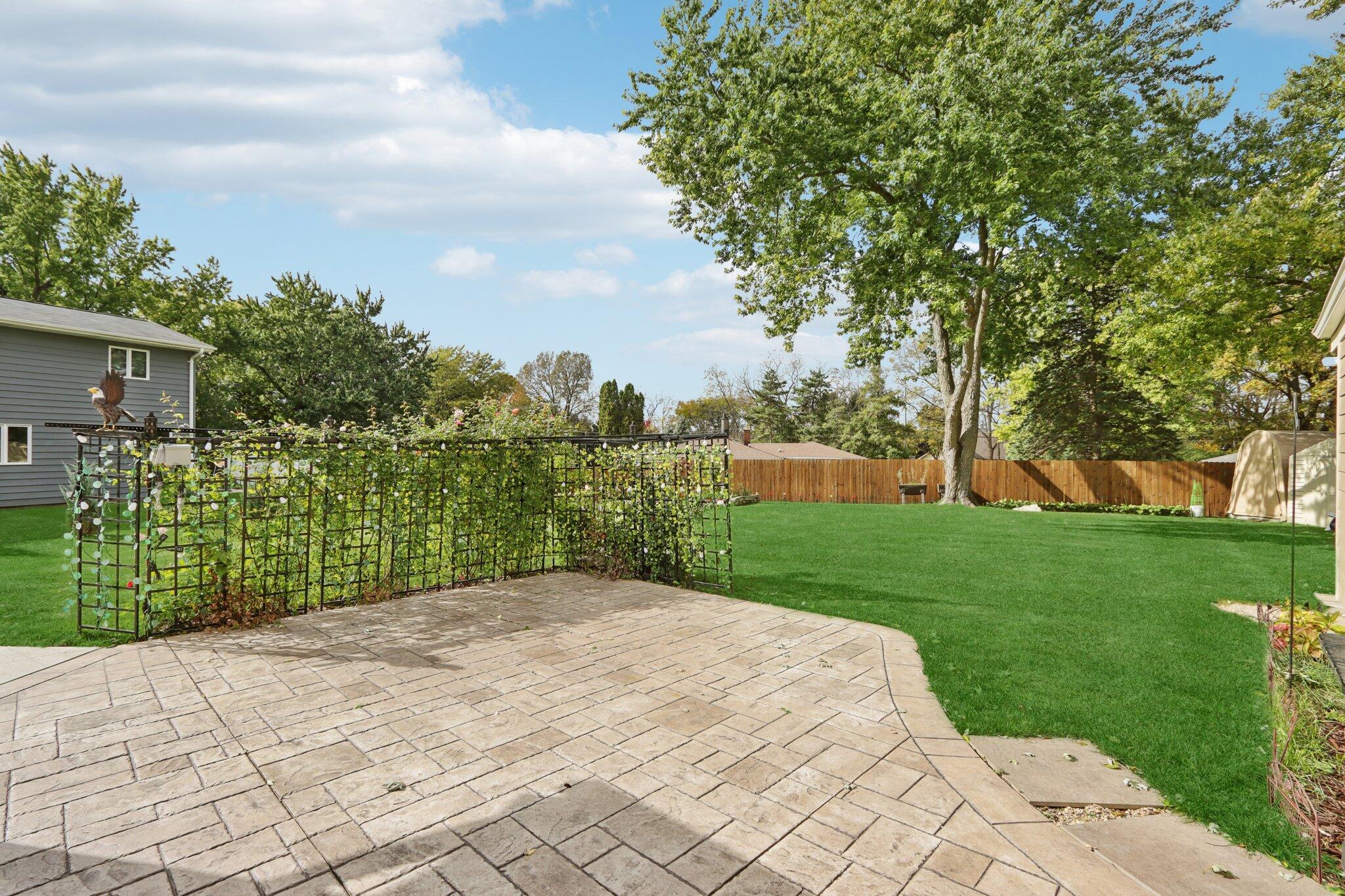 901 Anton Road Hartland, WI 53029 - Photo 35 of 48 Freshly installed stamped concrete patio opens to a tranquil backyard.