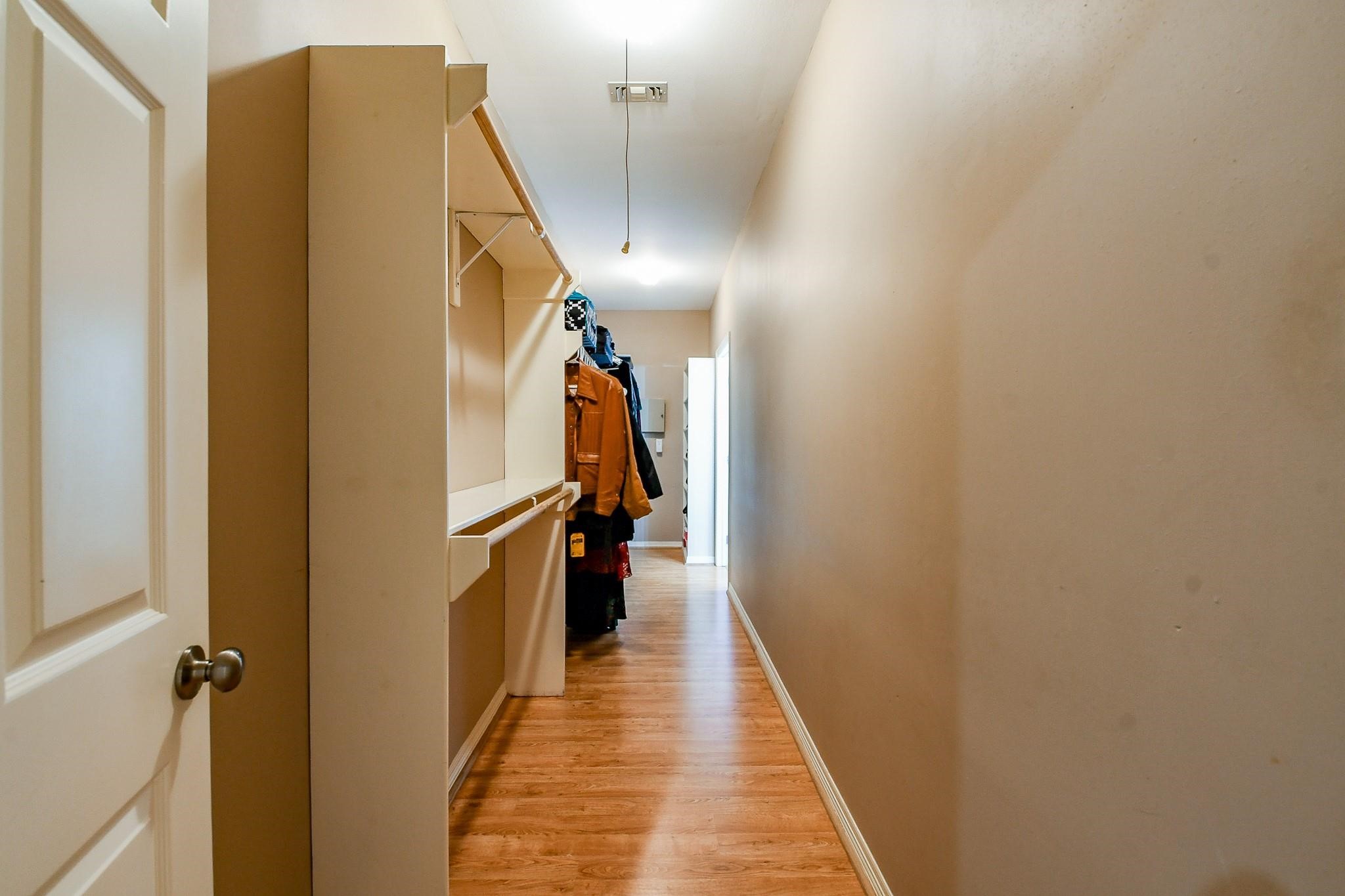 22035 Buescher Road Tomball, TX 77377 - Photo 23 of 43 a view of a hallway with wooden floor and staircase