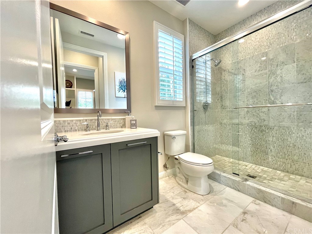 20744 Bur Oak Circle Porter Ranch, CA 91326 - Photo 14 of 36 a bathroom with a sink toilet and shower