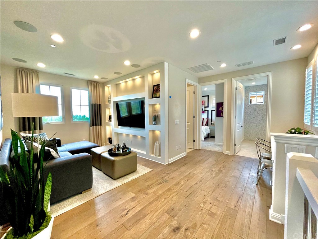 20744 Bur Oak Circle Porter Ranch, CA 91326 - Photo 15 of 36 a living room with furniture and a flat screen tv