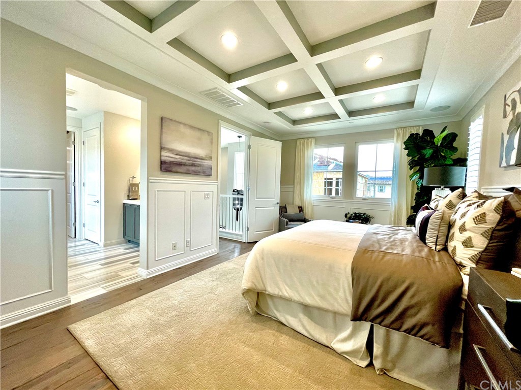 20744 Bur Oak Circle Porter Ranch, CA 91326 - Photo 20 of 36 a bedroom with a bed and large mirror with wooden floor