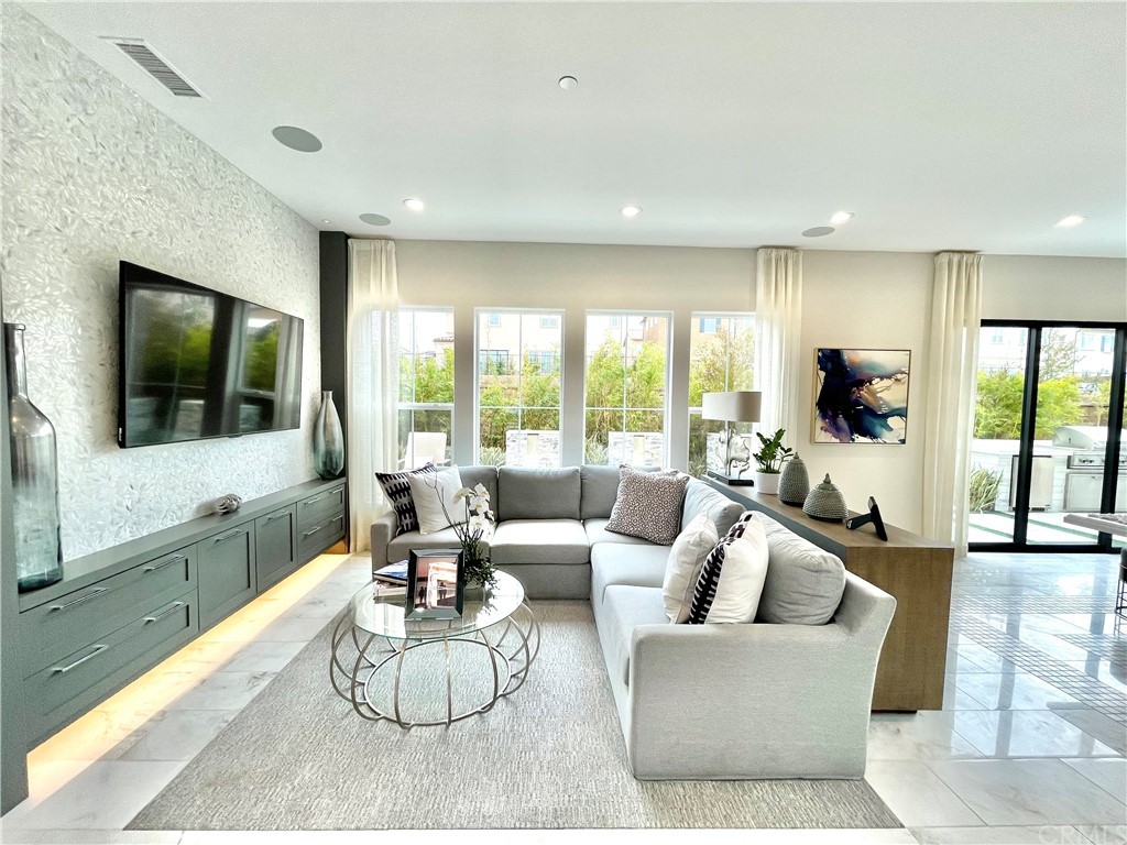 20744 Bur Oak Circle Porter Ranch, CA 91326 - Photo 3 of 36 a living room with furniture a flat screen tv and floor to ceiling window