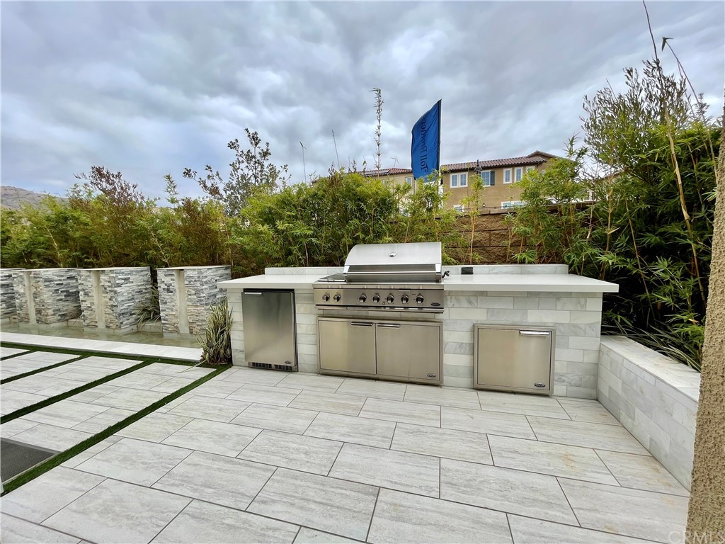 20744 Bur Oak Circle Porter Ranch, CA 91326 - Photo 34 of 36 a view of a kitchen with a stove top oven and cabinets