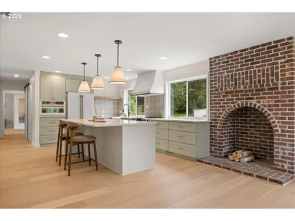 a kitchen with kitchen island white cabinets and white appliances