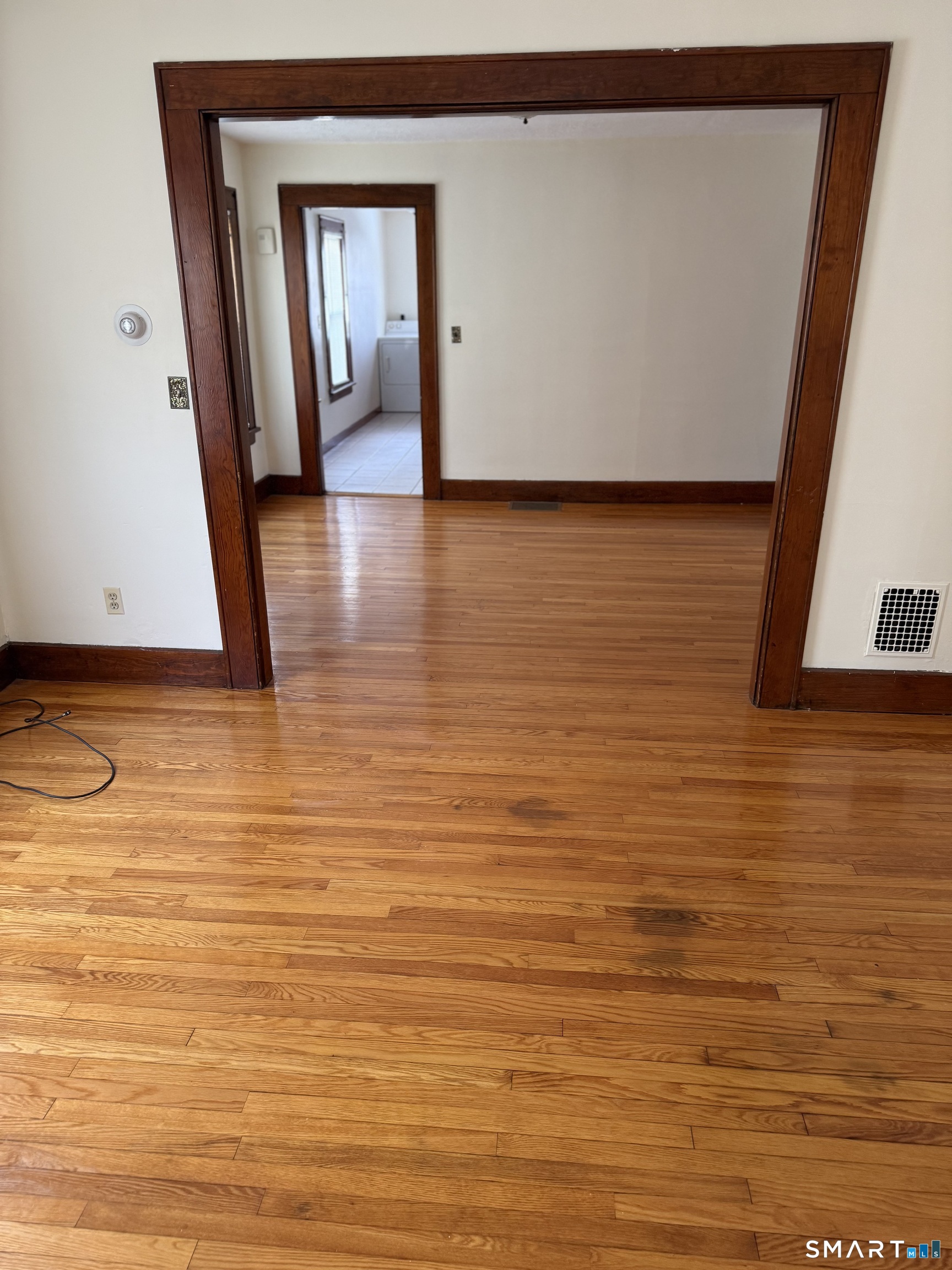 5 Gardners Lane Ansonia, CT 06401 - Photo 4 of 8 a view of a room with wooden floor and brick wall