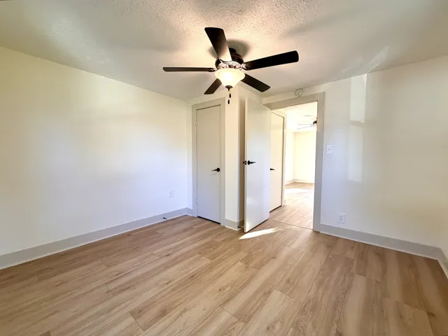a view of empty room with wooden floor