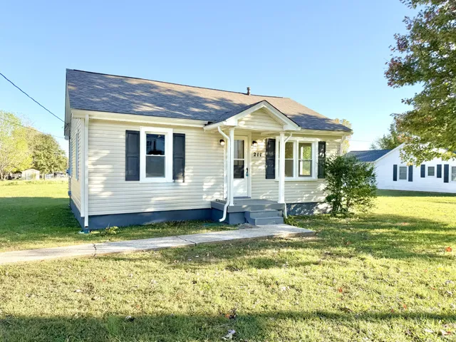 a front view of a house with a yard