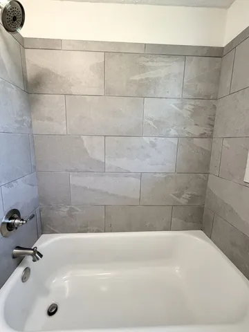 a bathroom with a white bath tub